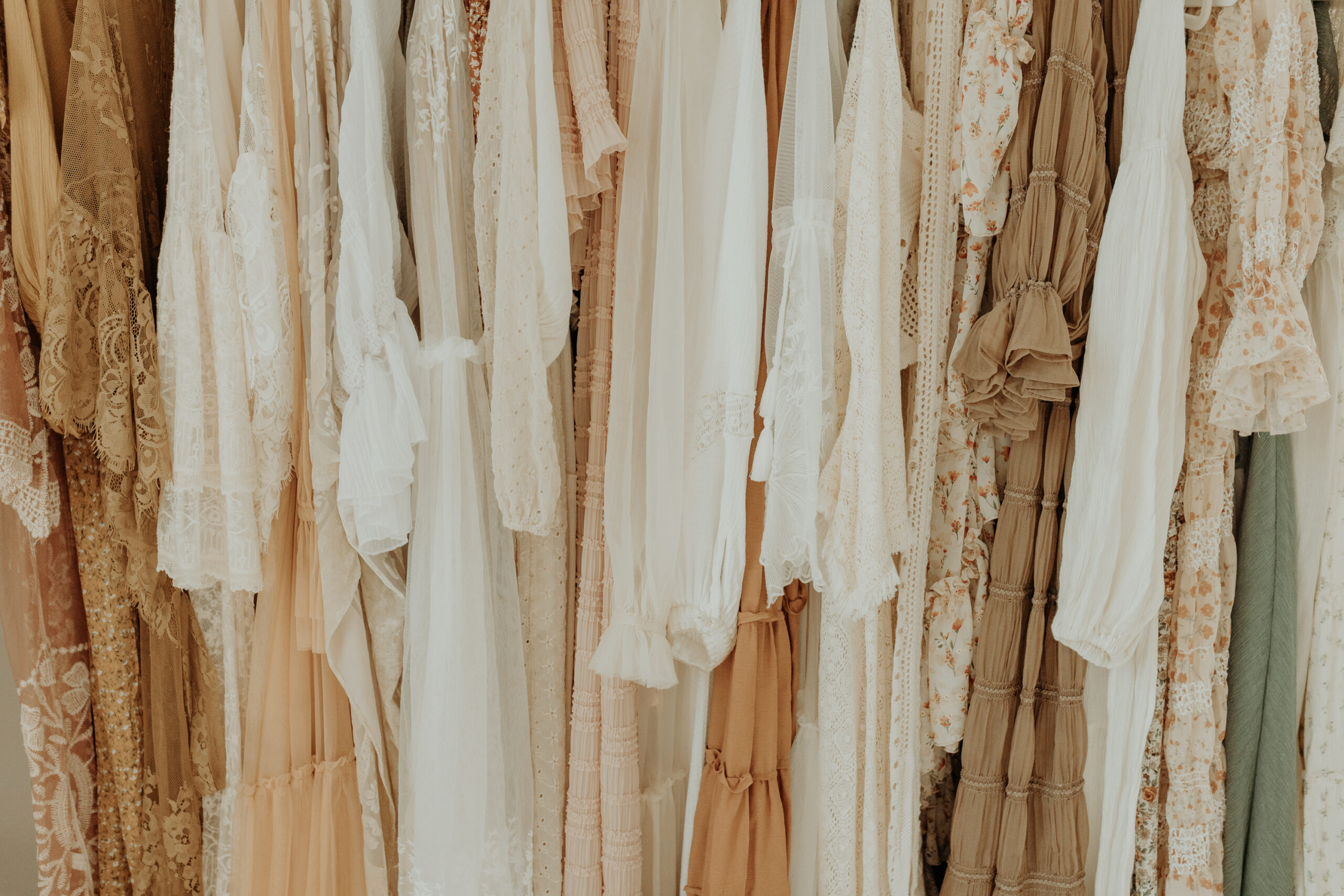 dresses lined up on a garment rack